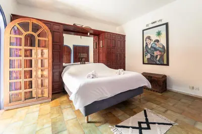 a bedroom with a large bed and wooden cabinets at Cozy Quiet Traditional Apartment in Dar Caïd Layadi