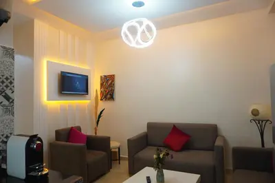 a living room with two couches and a tv at Lovely Studio a gulez centre marrakech in Marrakech