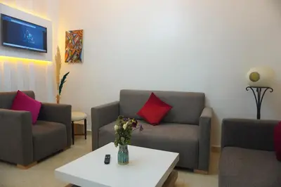 a living room with two couches and a table at Lovely Studio a gulez centre marrakech in Marrakech