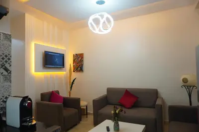 a living room with two couches and a tv at Lovely Studio a gulez centre marrakech in Marrakech