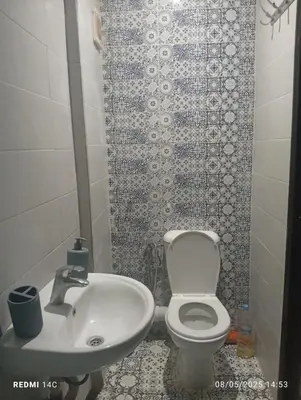 a bathroom with a white toilet and a sink at Appartement familial à Marrakech in Marrakech