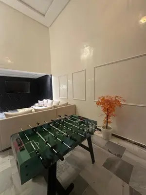 a ping pong table in a room with at le duplex spacieux comfort in Marrakech
