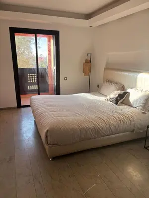 a large bed in a bedroom with a window at Menara Garden Gueliz Marrakech in Oulad Akkou