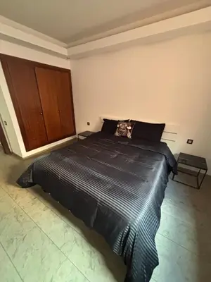 a bedroom with a bed with a cat sitting on it at Menara Garden Gueliz Marrakech in Oulad Akkou