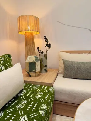 a room with a bed and a lamp and a couch at RIAD El Ma in Marrakech