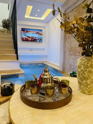 a tray with a tea kettle and cups on a table at RIAD El Ma in Marrakech