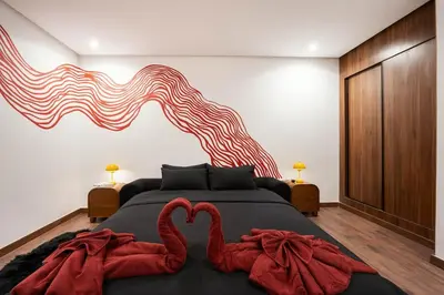 a bedroom with a bed with two red swans on it at Jacuzzi Private Terrace Design Central Apartment in Marrakech