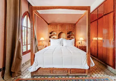 a bedroom with a large bed with a large mirror at Private 3 Bedroom Riad Exclusive Use for Families and Friends in Marrakech