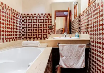 a bathroom with two sinks and a bath tub at Private 3 Bedroom Riad Exclusive Use for Families and Friends in Marrakech