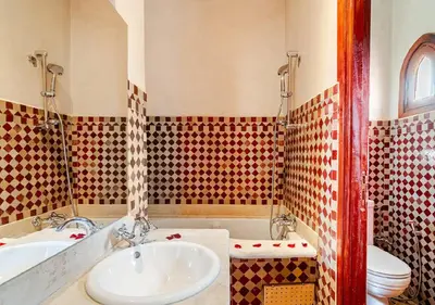 a bathroom with a sink and a tub and a toilet at Private 3 Bedroom Riad Exclusive Use for Families and Friends in Marrakech
