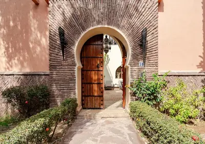 an entrance to a brick building with a wooden door at Private 3 Bedroom Riad Exclusive Use for Families and Friends in Marrakech