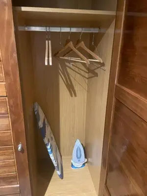 a cabinet with a surfboard and a hat in it at Sublime Appartement JACCUZi privé piscine in Marrakech
