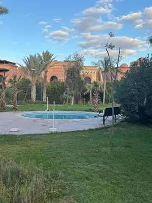 a swimming pool in the middle of a yard at Appartement atlas golf ressort in Marrakech