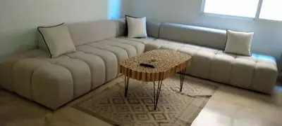 a living room with a white couch and a table at Appartement moderne trés securisé a gueliz au centre ville in Marrakech
