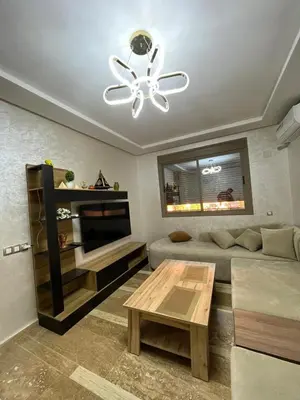 a living room with a couch and a ceiling fan at Appartement moderne 5 min au centre de ville proche du gueliz in Marrakech