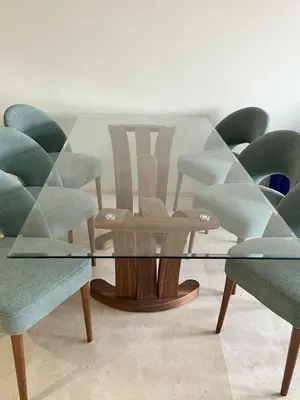 a glass table in a room with green chairs at Marrakech Mood in Marrakech
