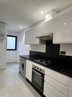 a kitchen with white cabinets and a stove top oven at Marrakech Mood in Marrakech