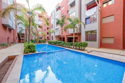 a swimming pool in the middle of a building at Sunny Luxe 2BR Heaven Apt Wi-Fi, Balcony & Pool in Marrakech