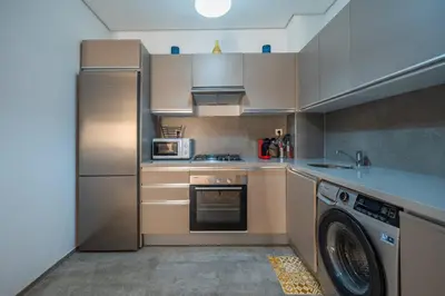 a kitchen with a washer and a dishwasher at Modern Hivernage Appt New 2-BR w Pool & Terrace in Marrakech