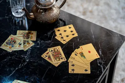 a table with playing cards and a teapot on it at Le Grand Chic in Marrakech