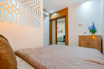 a bedroom with a bed and a painting on the wall at Le Grand Chic in Marrakech