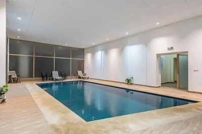 a swimming pool in a large room with a pool at Le Grand Chic in Marrakech