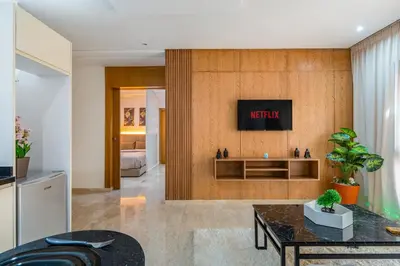 a living room with a tv on a wall at Le Grand Chic in Marrakech