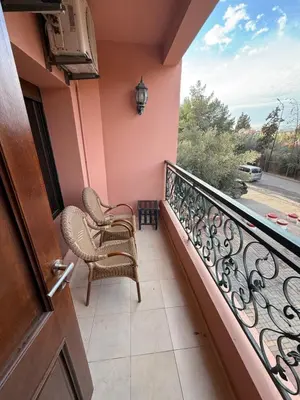 a balcony with two chairs and a window at Kech in Marrakech