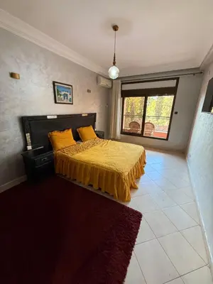 a bedroom with a bed with a yellow bedspread at Kech in Marrakech
