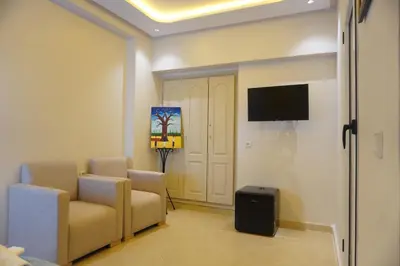 a room with two chairs and a flat screen tv at Cozy studio au Centre Marrakech in Marrakech