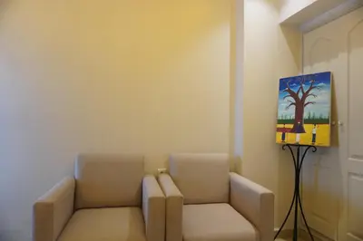 a room with two chairs and a painting on the wall at Cozy studio au Centre Marrakech in Marrakech