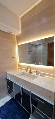 a bathroom with a sink and a large mirror at Elegant Apartment in Marrakech Premium Village with Five Pools & Free Parking in Marrakech