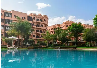 a swimming pool in front of a building at Elegant Apartment in Marrakech Premium Village with Five Pools & Free Parking in Marrakech