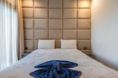 a bed with a blue blanket on top of it at Luxury Stay in Prestigia Garden and Pool in Marrakech
