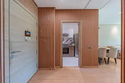 a hallway with a door leading to a kitchen at Luxury Stay in Prestigia Garden and Pool in Marrakech