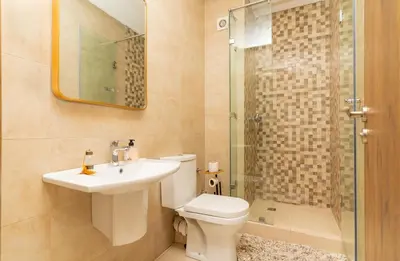 a bathroom with a toilet and a sink and a shower at Luxury Apartment Hivernage 5 minutes from Jemaa El Fna in Marrakech