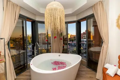 a bath tub in a bathroom with a large window at Studio au cœur de Guéliz à 5 min de Jemaa el-Fna in Marrakech