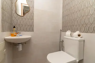 a bathroom with a white toilet and a sink at Studio au cœur de Guéliz à 5 min de Jemaa el-Fna in Marrakech