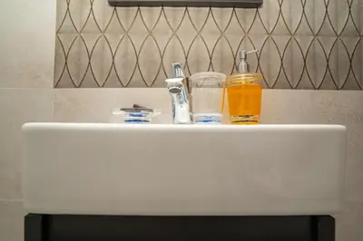 a white sink with two bottles of orange liquid on it at Studio au cœur de Guéliz à 5 min de Jemaa el-Fna in Marrakech