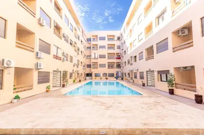 an empty courtyard with a swimming pool in a building at Studio Hivernage 2 munit a la gare in Marrakech