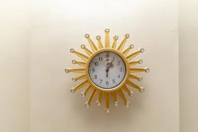 a clock on a wall with a gold sun at Studio Hivernage 2 munit a la gare in Marrakech