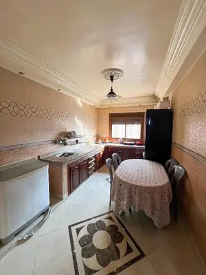 a kitchen with a table and a small table with chairs at Nice Apartment in Marrakesh in Marrakech