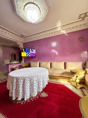 a living room with a table and a couch at Nice Apartment in Marrakesh in Marrakech