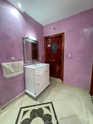 a bathroom with a sink and a mirror and purple walls at Nice Apartment in Marrakesh in Marrakech