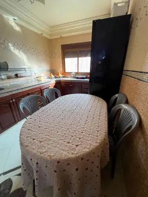 a kitchen with a table with chairs and a counter at Nice Apartment in Marrakesh in Marrakech