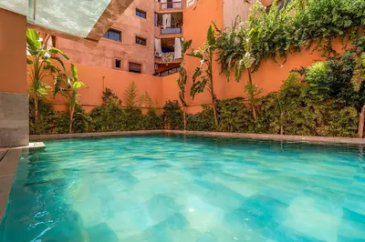 a swimming pool in front of a building at Prestigious Duplex in the Center of Guéliz in Marrakech
