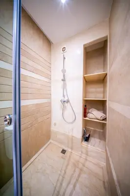 a bathroom with a shower and a walk in shower at Prestigious Duplex in the Center of Guéliz in Marrakech
