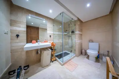 a bathroom with a sink and a shower and a toilet at Prestigious Duplex in the Center of Guéliz in Marrakech