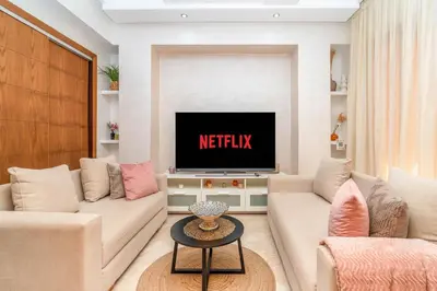 a living room with two couches and a tv at Prestigious Duplex in the Center of Guéliz in Marrakech