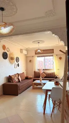 a living room with a couch and a table at A haven of light & sweetness in Marrakech